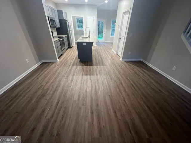 a kitchen with granite countertop a sink and steel appliances