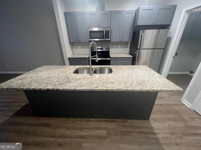 a kitchen with a refrigerator and a stove