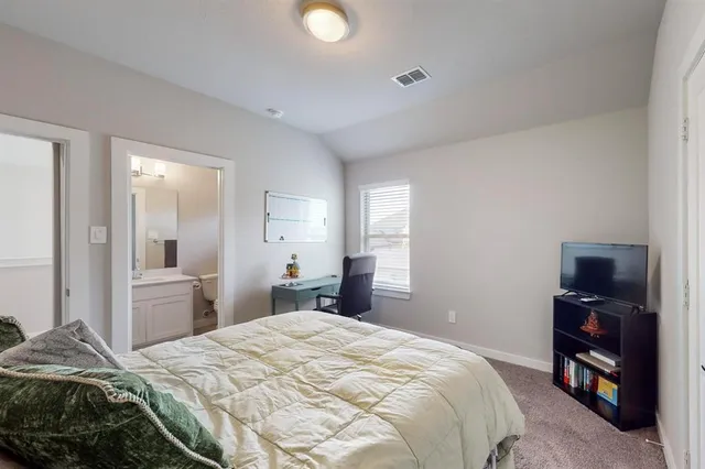 a bedroom with a bed a desk and chair