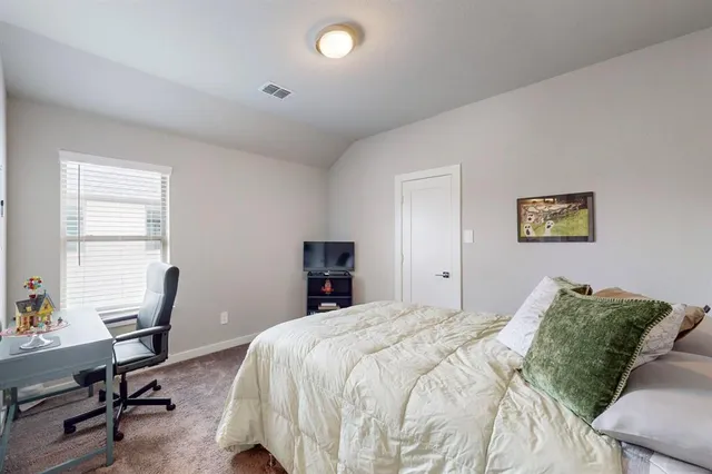 a bedroom with bunk bed and a window