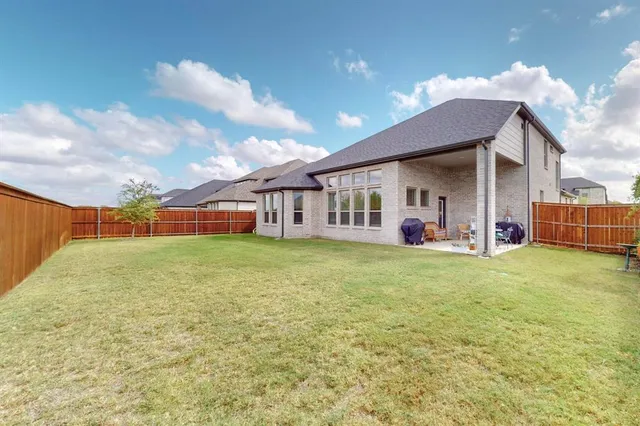 a view of a porch with furniture and yard