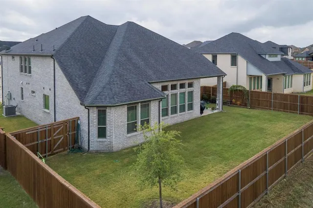 a front view of a house with yard and tress