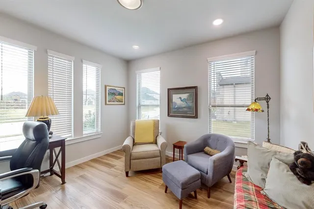 a kitchen with granite countertop a table chairs stainless steel appliances and cabinets
