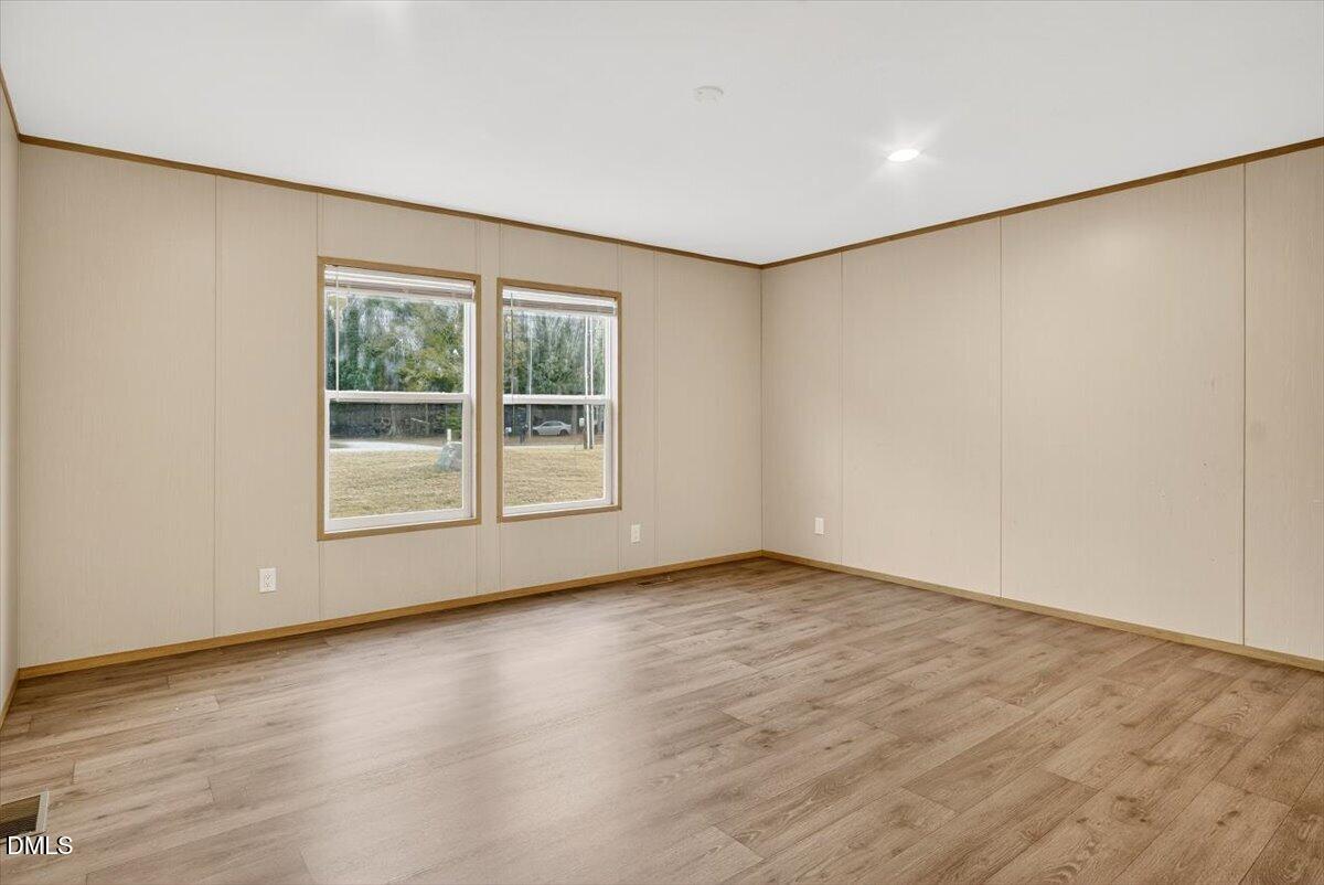 532 Plum Nutty Road Henderson, NC 27537 - Photo 15 of 38 an empty room with wooden floor and windows