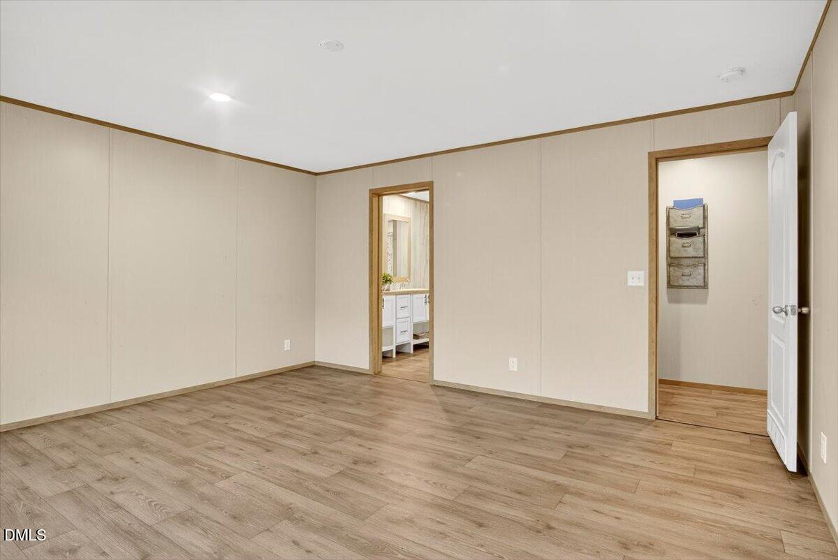 532 Plum Nutty Road Henderson, NC 27537 - Photo 16 of 38 a view of an empty room with wooden floor and closet