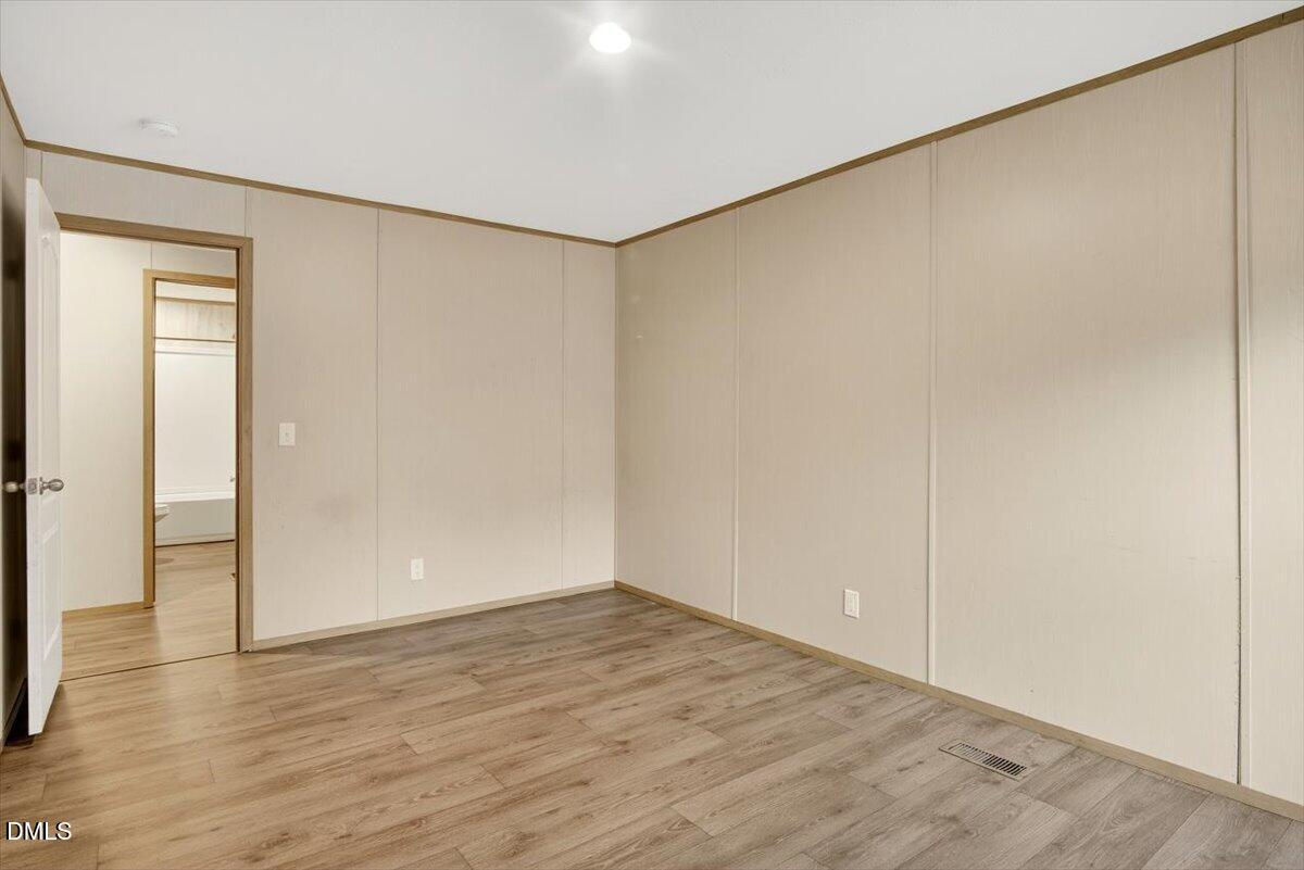 532 Plum Nutty Road Henderson, NC 27537 - Photo 17 of 38 a view of an empty room with wooden floor