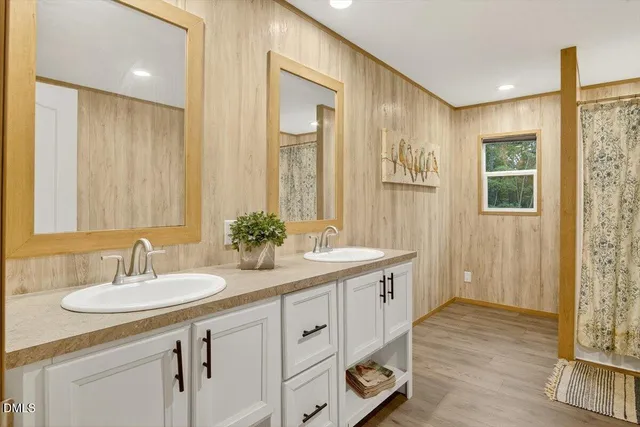 a bathroom with 2 sink and a mirror