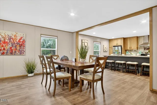 a view of a dining room with furniture and a large window
