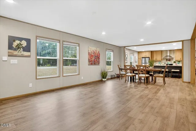 a view of a big room with dining room wooden floor and windows