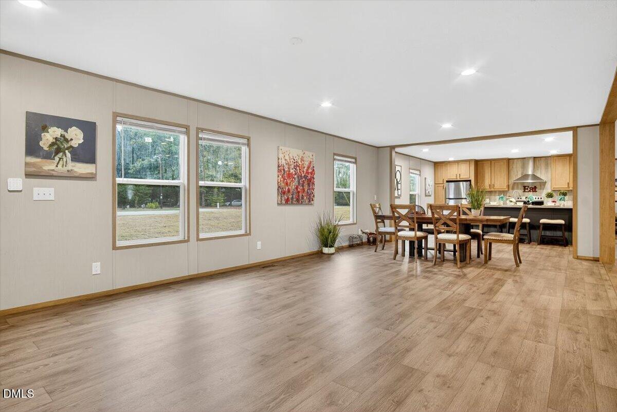 532 Plum Nutty Road Henderson, NC 27537 - Photo 8 of 38 a view of a big room with dining room wooden floor and windows