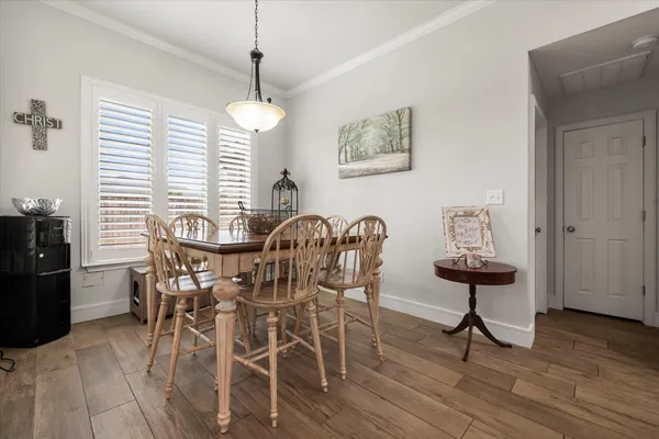 a view of a dining room with furniture and wooden floor