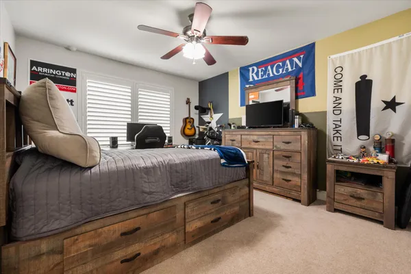 a bedroom with furniture and a flat screen tv