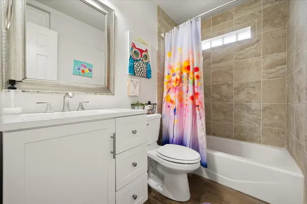 a bathroom with a sink toilet and shower