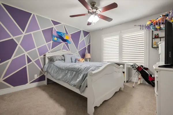 a bedroom with a bed and a chandelier