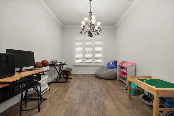 a bedroom with furniture and a wooden floor