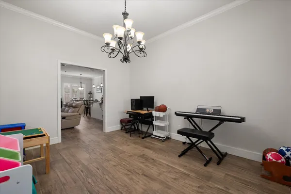 a living room with furniture and a chandelier