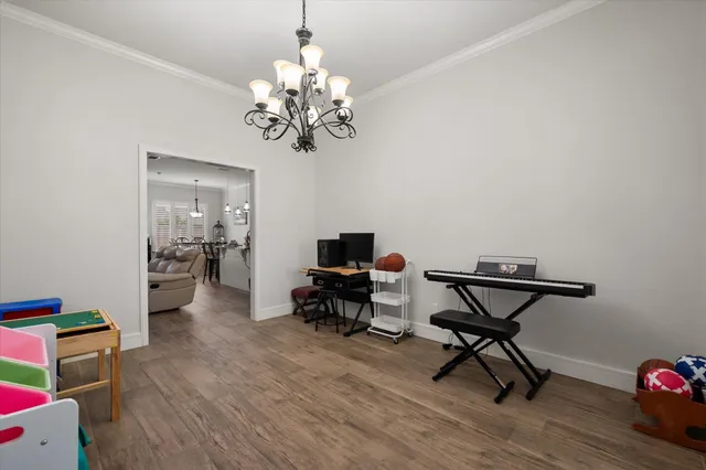 a living room with furniture and a chandelier