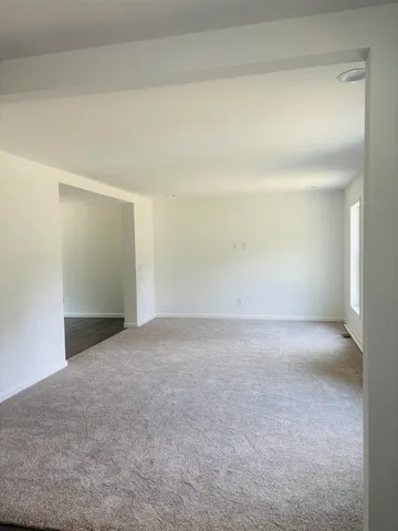 an empty room with wooden floor and closet