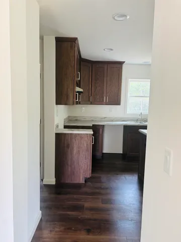 a view of a big room with wooden floor and a window