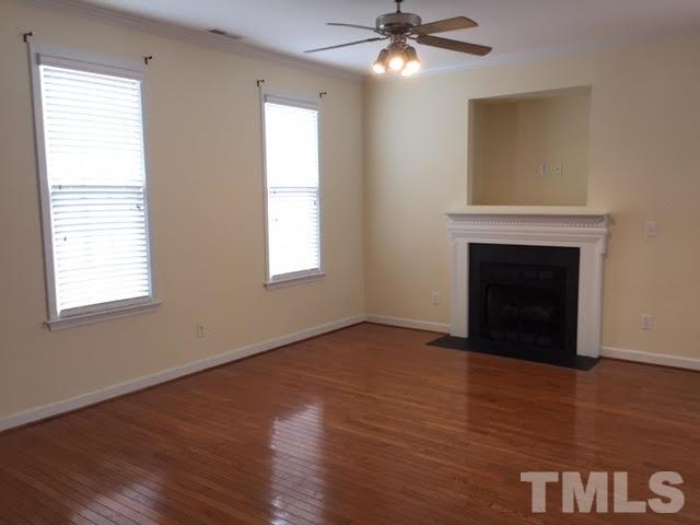 4701 Malone Court Raleigh, NC 27616 - Photo 8 of 16 Gas log fireplace in the large living room with oak hardwood floors.