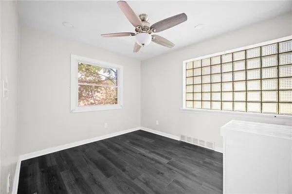 a kitchen with a stove a sink a chimney a refrigerator and a window