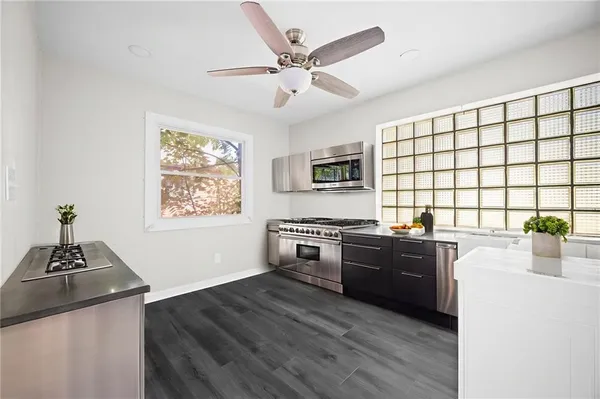 a kitchen with sink cabinets and wooden floor