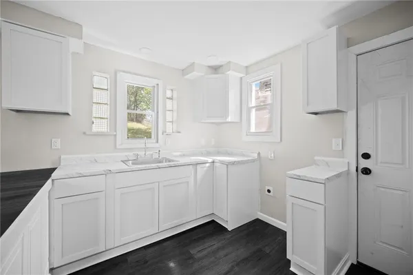 a kitchen with a sink cabinets and window