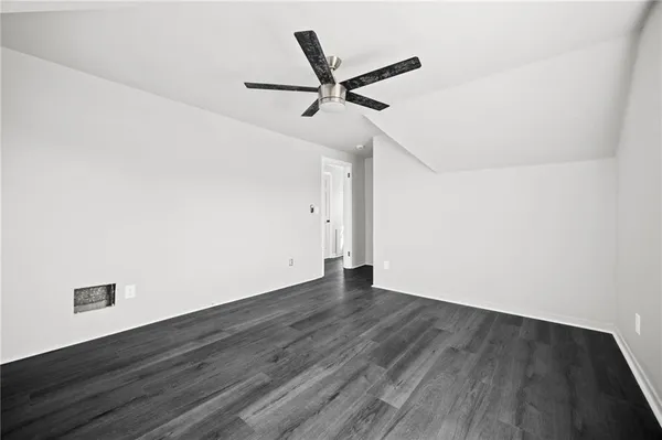 a bedroom with a bed and a potted plant