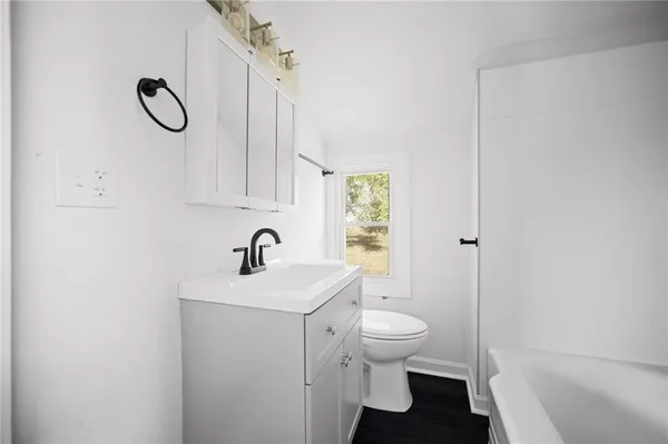 a bathroom with a granite countertop bathtub shower and sink
