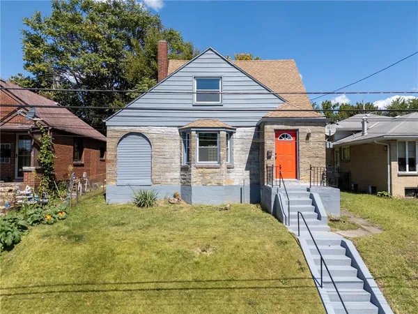 a view of a hallway with wooden floor and stairs
