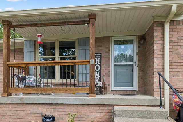 a view of a dining room with furniture a chandelier and wooden floor