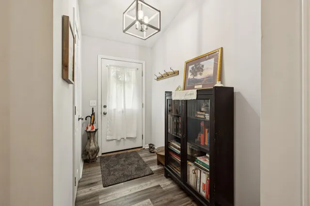 a view of a dining room with furniture a fireplace and wooden floor