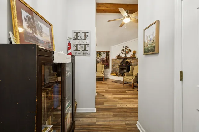 a living room with furniture a flat screen tv and a floor to ceiling window