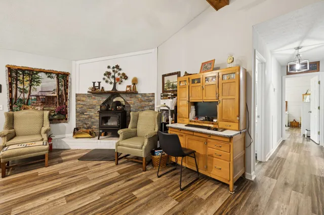 a living room with furniture a wooden floor and a flat screen tv