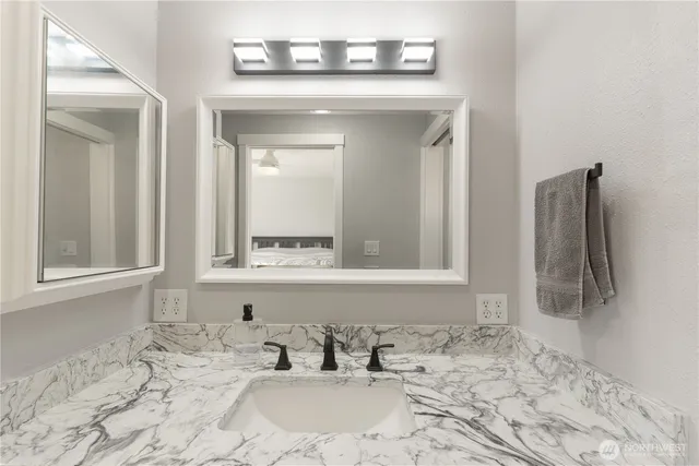 a bathroom with a sink and a mirror