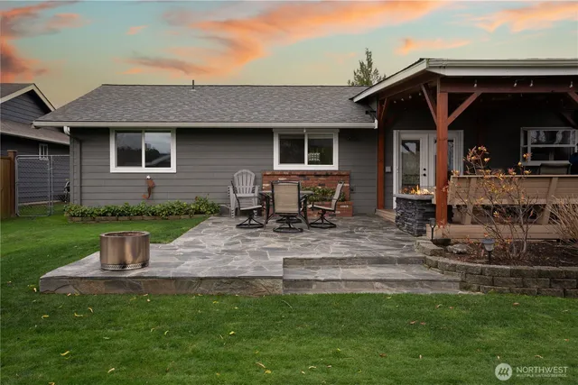 a view of a chairs and table in backyard