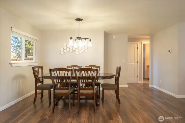 a view of a dining room with furniture window and wooden floor