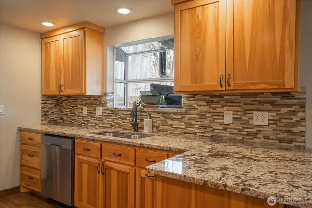 a bathroom with a granite countertop sink and a mirror