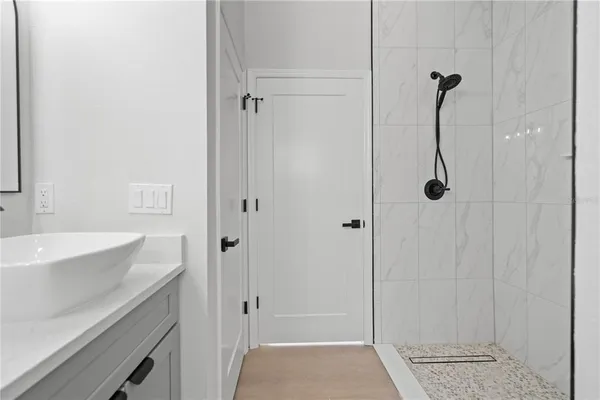a bathroom with a shower and a sink