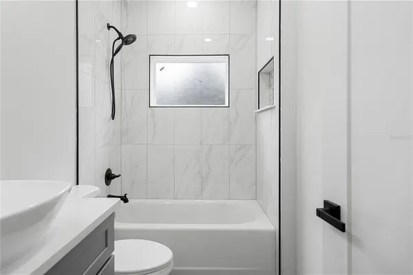 a bathroom with a shower bathtub and toilet
