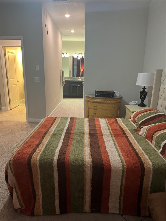 17361 Old Tobacco Road Lutz, FL 33558 - Photo 16 of 27 a bedroom with a bed and a mirror