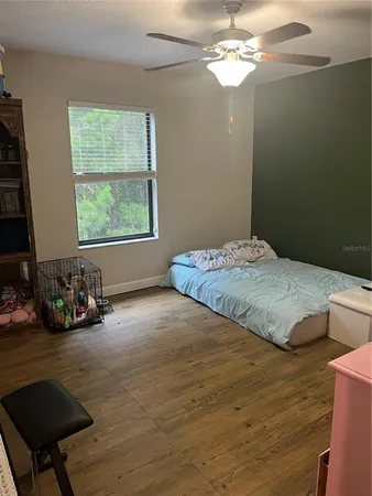a bedroom with a bed and a mirror