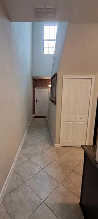a view of a hallway to rooms