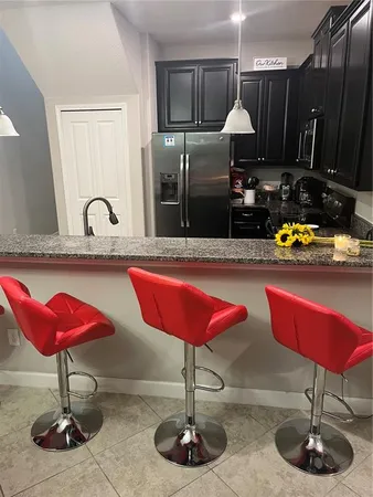 a kitchen with table and chairs