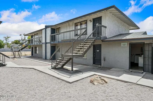 a front view of a house with sitting area