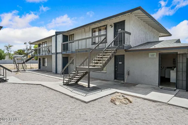 a front view of a house with sitting area