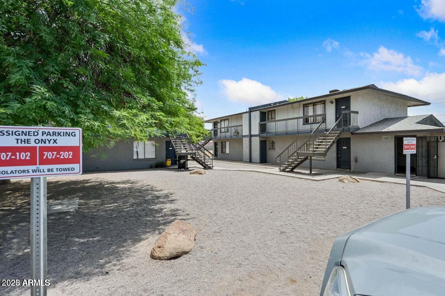 719 East Roeser Road, Unit 201 Phoenix, AZ 85040 - Photo 2 of 13 a front view of a house with a yard and garage