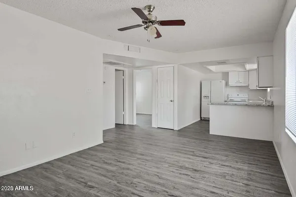 a view of a kitchen with wooden floor and a kitchen
