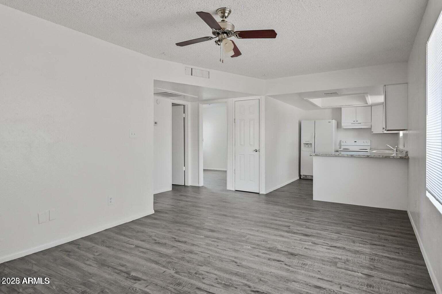 719 East Roeser Road, Unit 201 Phoenix, AZ 85040 - Photo 3 of 13 a view of a kitchen with wooden floor and a kitchen