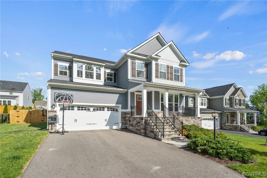 4125 Cambrian Circle Midlothian, VA 23112 - Photo 2 of 21 a front view of a house with a yard and garage